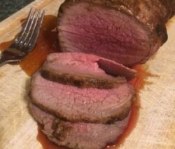 Sliced roast beef on a cutting board.