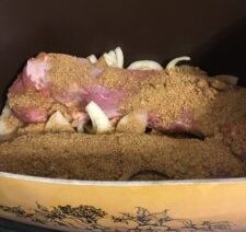 Raw meat seasoned in a slow cooker.