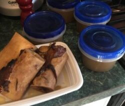 Bones and broth in containers on counter.
