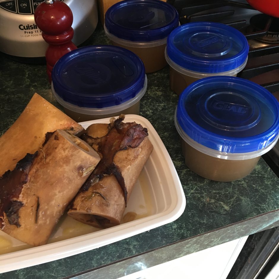 Takeout containers with egg rolls and dipping sauces.