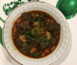 Beef stew in white bowl, festive decorations.