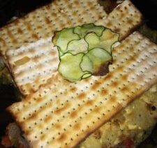 Matzo with sliced cucumber on top.