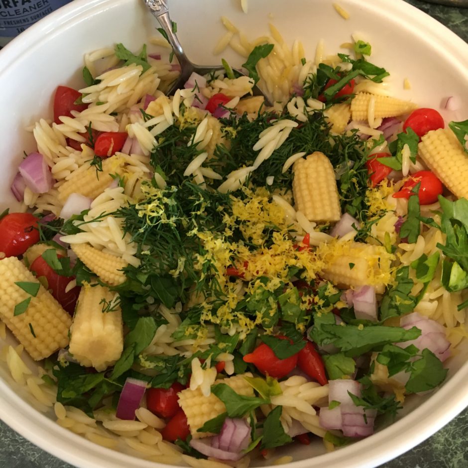 Fresh salad with colorful vegetables and herbs.