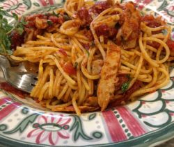 Plate of spaghetti with shrimp and tomato sauce.