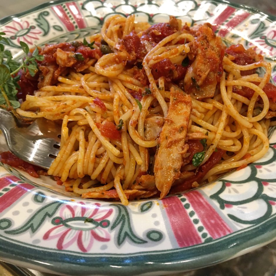 Plate of spaghetti with shrimp and tomato sauce.