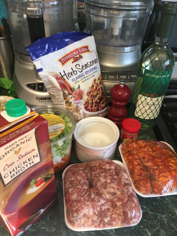 Ingredients for a hearty Italian meal including sausage, tomato sauce, beans, and spices.