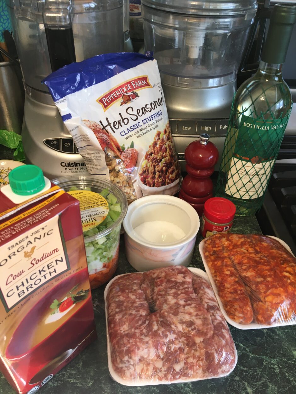 Ingredients for a hearty Italian meal including sausage, tomato sauce, beans, and spices.