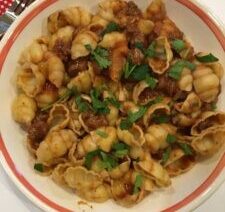 Pasta with meat sauce and fresh herbs.
