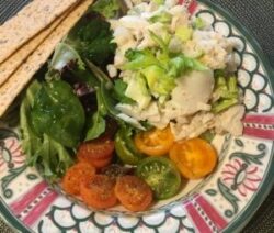 Salad with tomatoes, greens, and crackers.