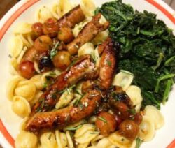 Pasta with sausage, tomatoes, and spinach.